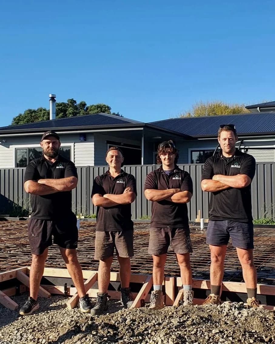 Building crew standing on a new house foundation
