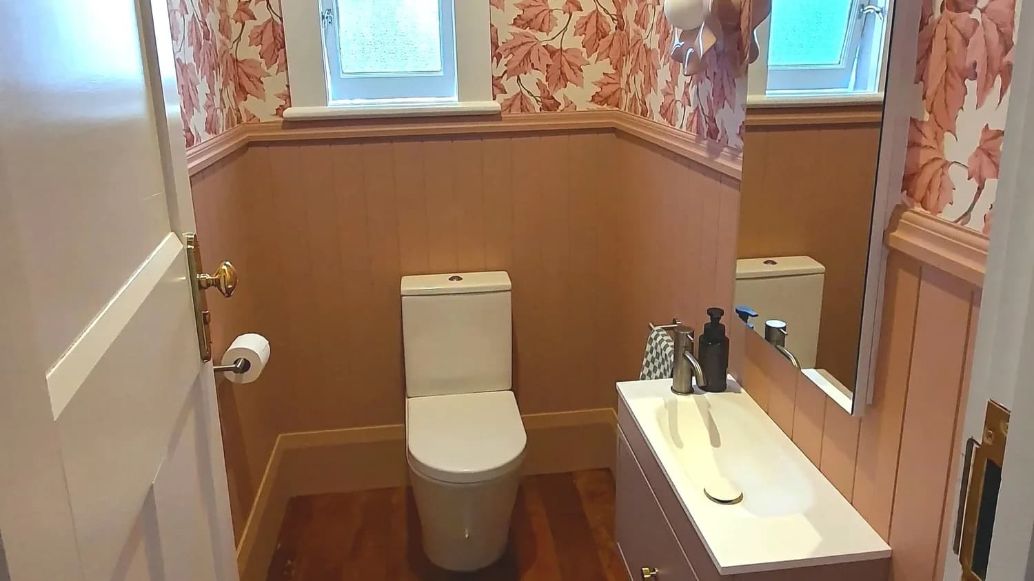 Renovated powder room with wallpaper, panelling and a new vanity